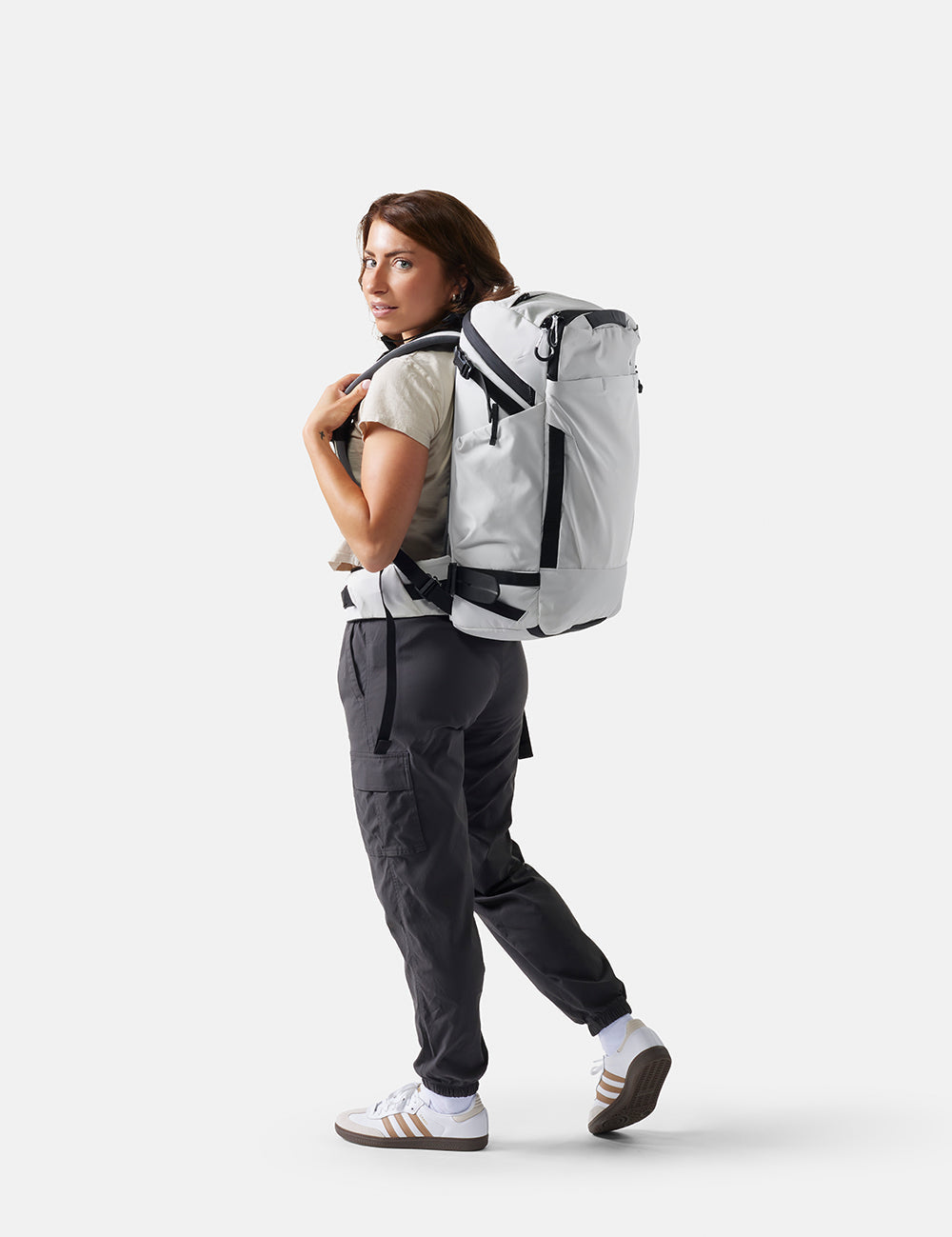 Person wearing a white backpack on a white background