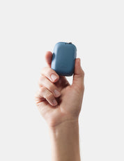 Hand holding slate nanodry case against a white background