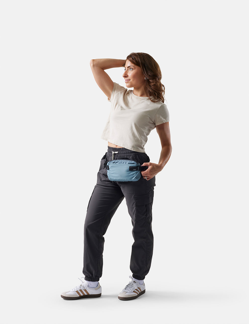 Woman wearing a waist bag on a white background